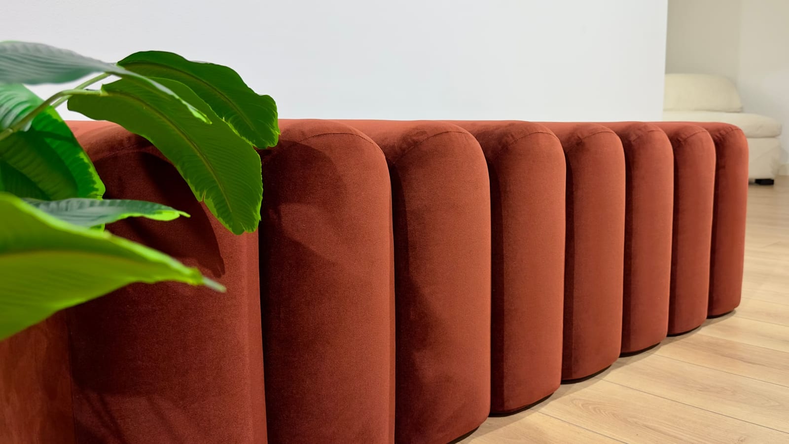 Terracotta channel-tufted sofa at the Petra Home showroom